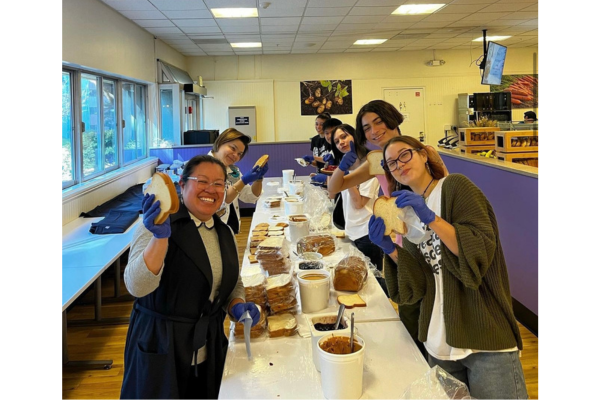 Student making Pb & J's at City Eats 