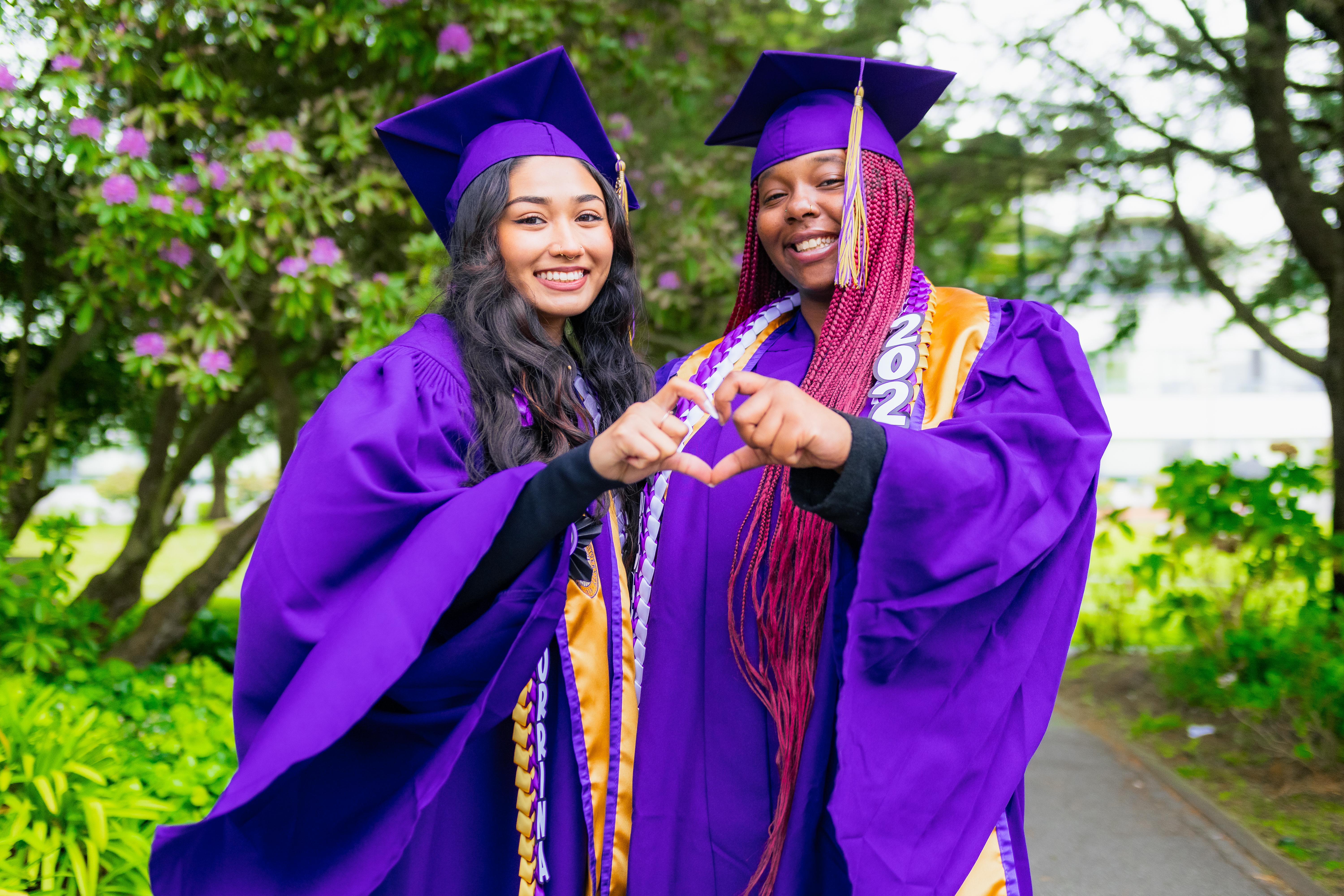 two graduates, women identifying